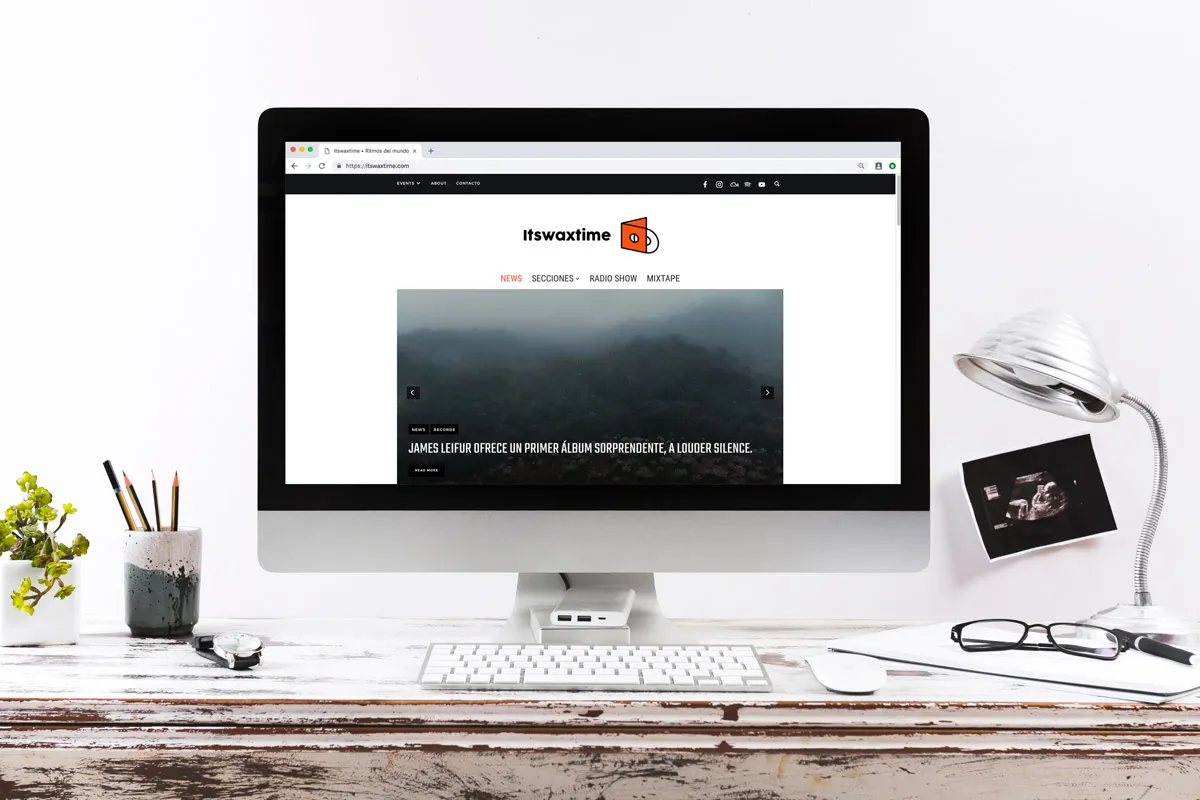 The Itswaxtime online magazine shown on a desktop monitor