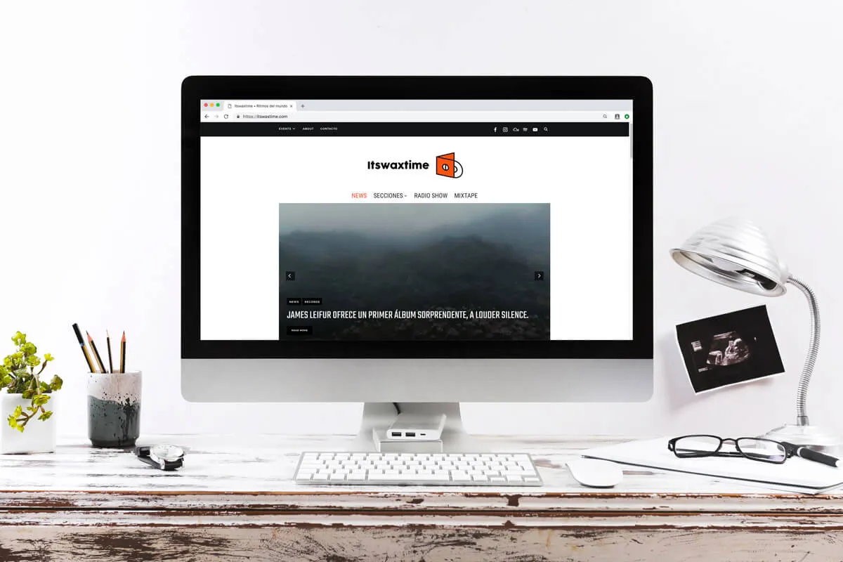 The Itswaxtime online magazine shown on a desktop monitor